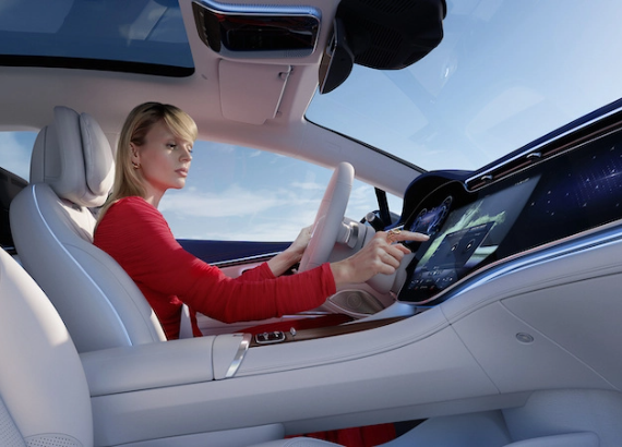 Driver touching the screen inside an EQS