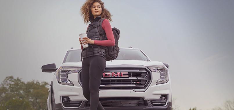 Model Standig Infront of GMC Vehicle