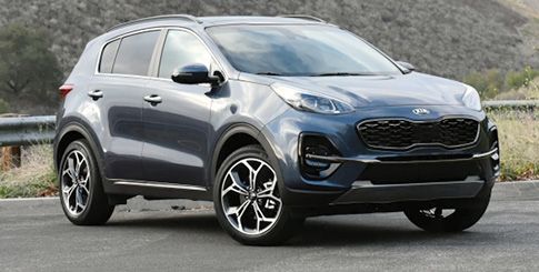 A blue Kia Sportage SUV parked on an asphalt road.