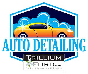 The rear view of a red sedan parked on the side of a rural road, with green hills in the distance.