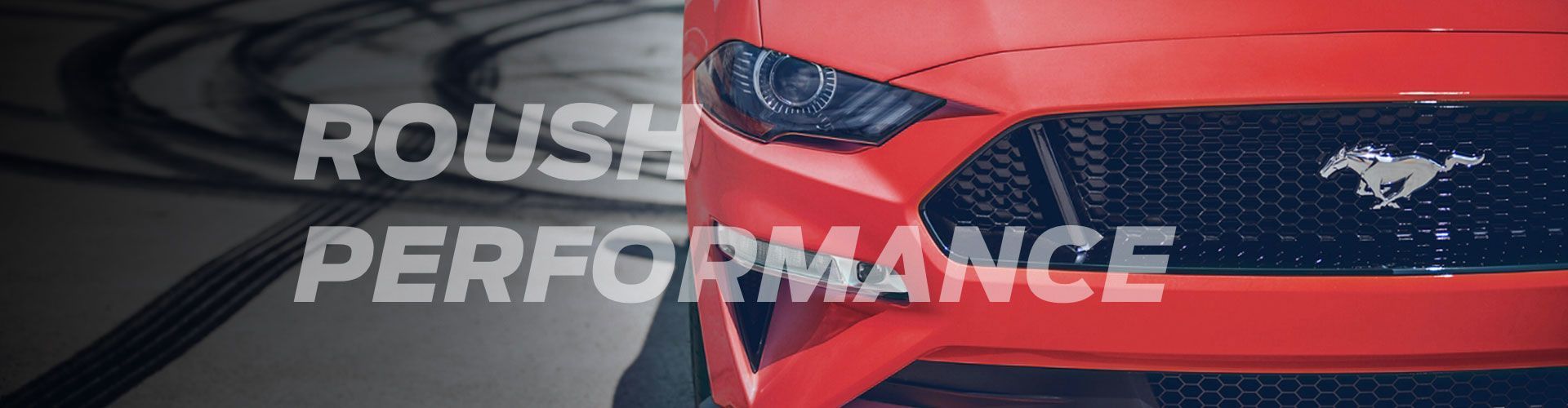Close-up of the front of a red Ford Mustang with overlaid text "ROUSH PERFORMANCE".
