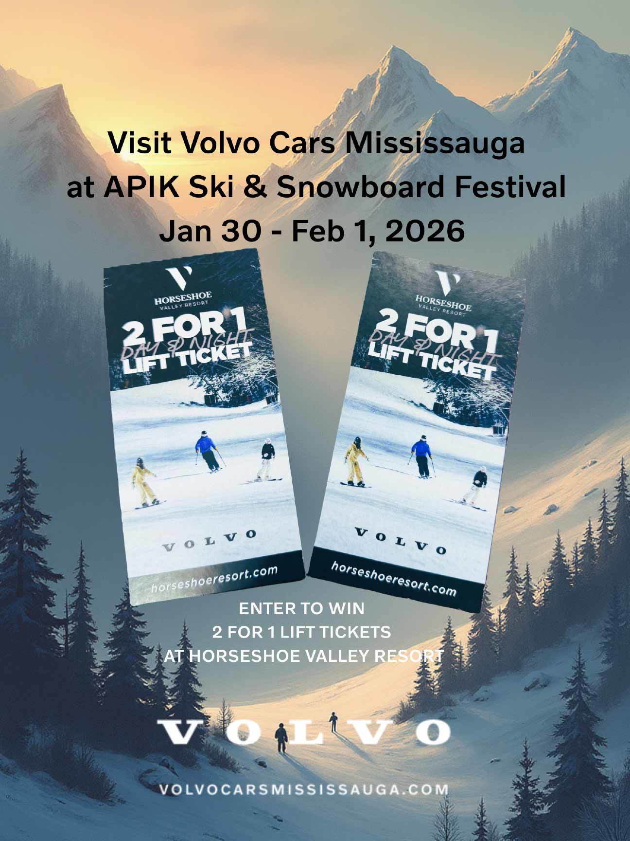 A smiling woman stands in a car dealership, looking at her smartphone while holding a takeaway coffee cup.