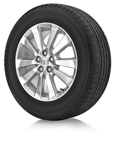 A single car wheel with a black tire and a silver multi-spoke rim, featuring the Toyota logo in the center hubcap, shown against a white background.