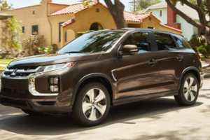 A brown Mitsubishi RVR parked on the street