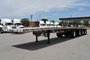 Quad-axle flatbed with a self steering for short-term rental at Location Brossard