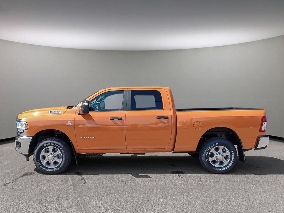 2024 Ram 3500 BIG HORN IN OMAHA ORANGE EQUIPPED WITH A 6.7L CUMMINS HO TURBO DIESEL I6 , 4X4 , 6SPD AISIN HD AUTO , 12INCH W/NAV , ALPINE AUDI-2